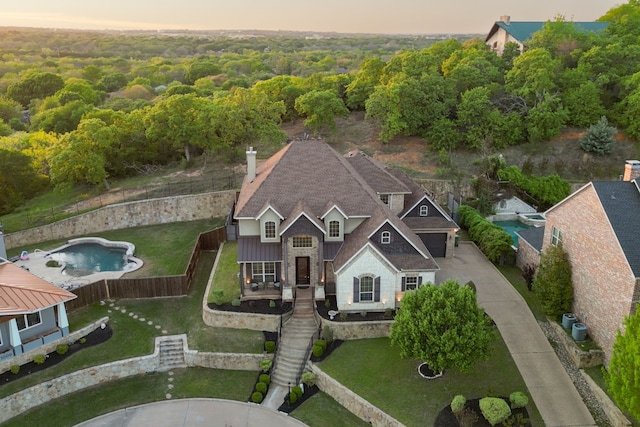 3007 Sunray Valley Ct, Arlington, TX 76012 - aerial view at dusk of view of pool and a wooded view