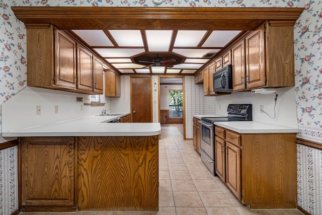 4924 Wolf Creek Trl, Flower Mound, TX 75028 - kitchen with black microwave, a ceiling fan, electric range, and wallpapered walls