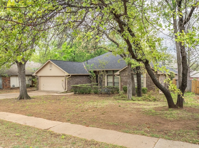 4924 Wolf Creek Trl, Flower Mound, TX 75028 - view of front of home with roof with shingles, fence, brick siding, an attached garage, and concrete driveway
