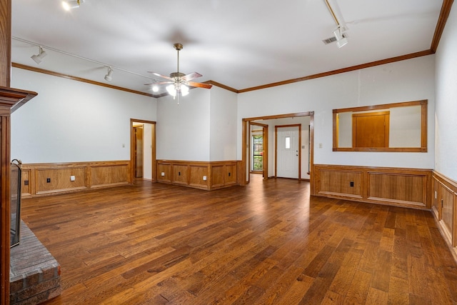 4924 Wolf Creek Trl, Flower Mound, TX 75028 - unfurnished living room featuring rail lighting, hardwood / wood-style flooring, ornamental molding, and a wainscoted wall