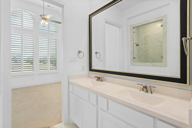 full bath with a ceiling fan, a sink, double vanity, and tiled shower