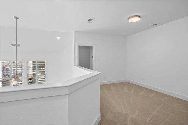 unfurnished room with recessed lighting, visible vents, light carpet, and baseboards