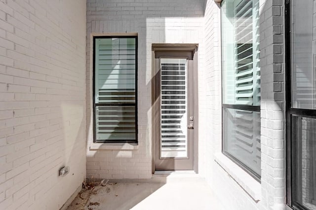 property entrance with brick siding