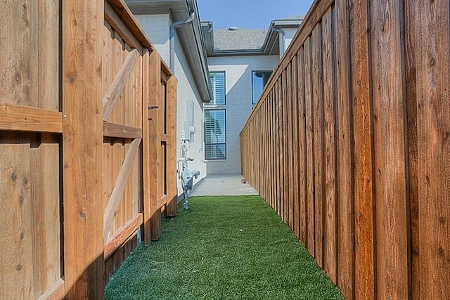 view of side of home featuring a lawn and board and batten siding