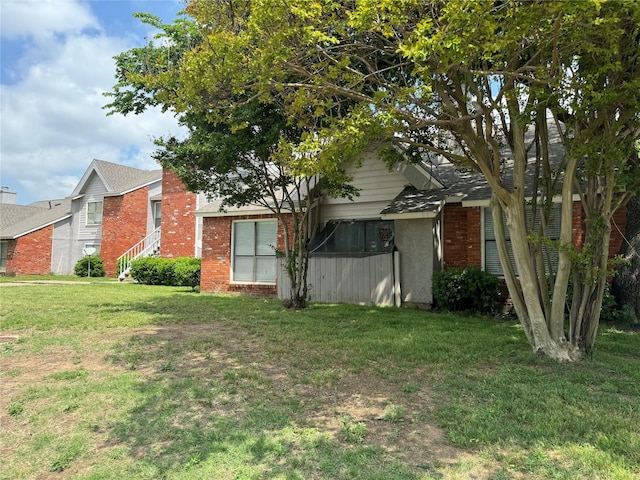 7413 Bogart Dr, North Richland Hills, TX 76180 - exterior space with brick siding and a yard