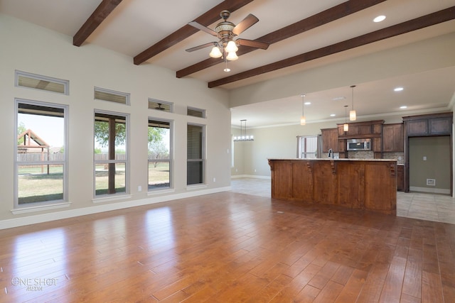125 Mountain Meadow Dr, Tuscola, TX 79562 - unfurnished living room featuring light wood-style floors, ceiling fan with notable chandelier, recessed lighting, baseboards, and beam ceiling