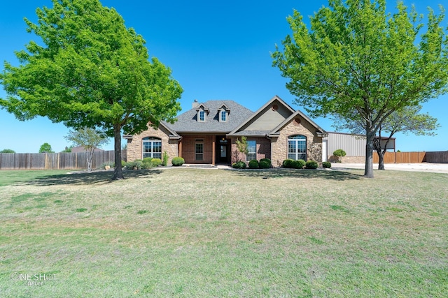 125 Mountain Meadow Dr, Tuscola, TX 79562 - view of front of house with roof with shingles, stone siding, fence, and a front lawn