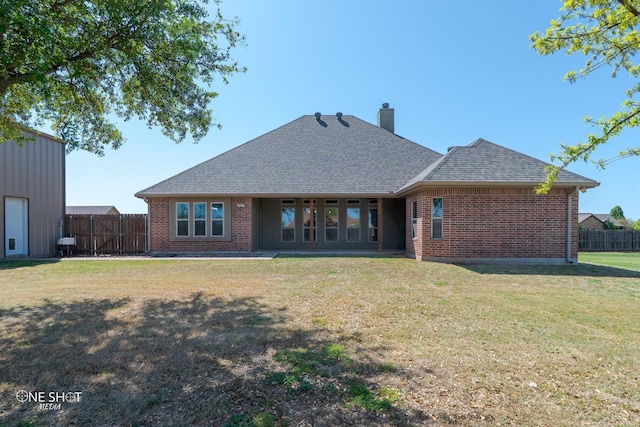 125 Mountain Meadow Dr, Tuscola, TX 79562 - back of house with roof with shingles, a chimney, brick siding, fence, and a lawn