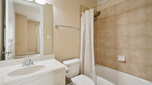 bathroom featuring vanity, a textured wall, toilet, and shower / tub combo with curtain