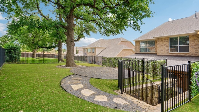 view of yard featuring a patio, a fenced backyard, and a gate