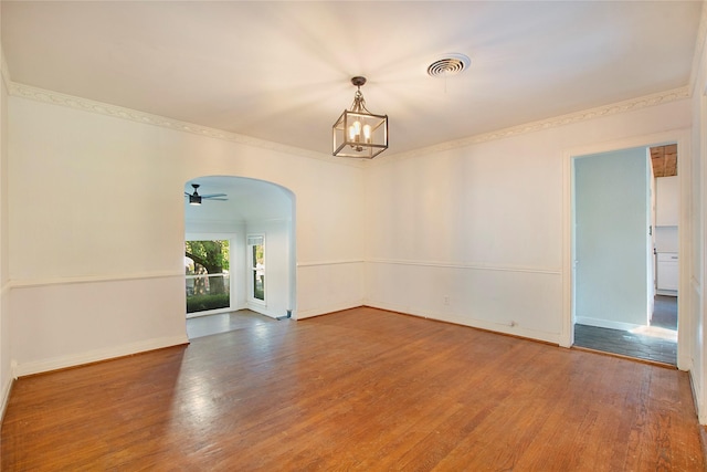 626 N Hampton Rd, Dallas, TX 75208 - empty room featuring arched walkways, wood finished floors, baseboards, and visible vents