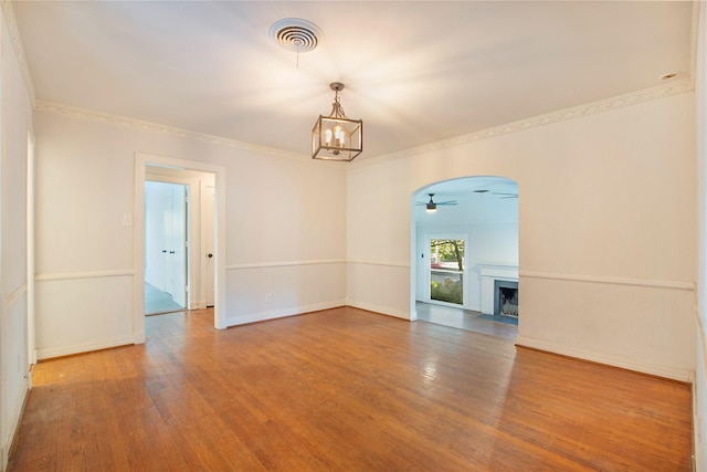 626 N Hampton Rd, Dallas, TX 75208 - spare room with crown molding, ceiling fan with notable chandelier, visible vents, wood-type flooring, and baseboards