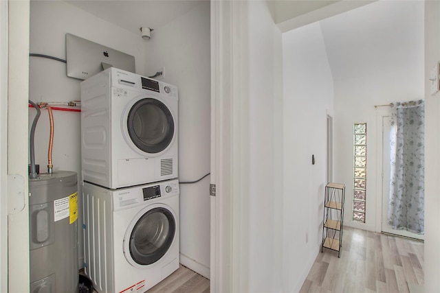 626 N Hampton Rd, Dallas, TX 75208 - clothes washing area with light wood-style floors, stacked washer and clothes dryer, laundry area, and water heater