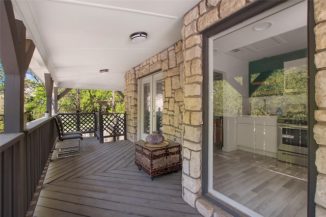 626 N Hampton Rd, Dallas, TX 75208 - wooden terrace with french doors and covered porch