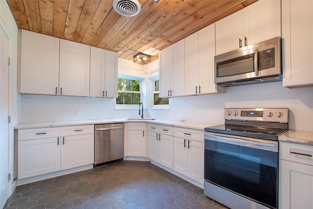 626 N Hampton Rd, Dallas, TX 75208 - kitchen featuring tasteful backsplash, a sink, white cabinetry, stainless steel appliances, and wooden ceiling