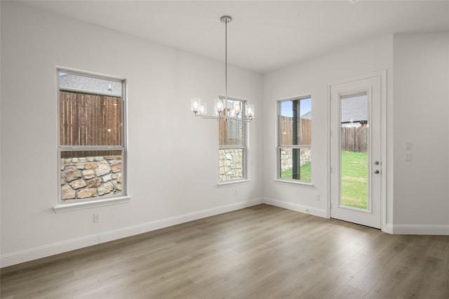 424 Lamb Ln, Waxahachie, TX 75167 - unfurnished dining area with wood finished floors, a chandelier, and baseboards
