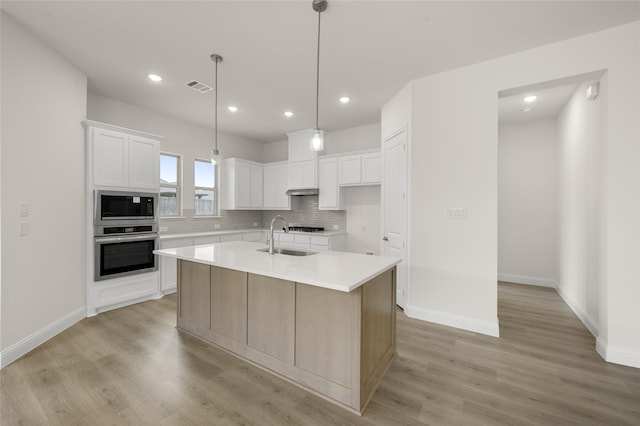 424 Lamb Ln, Waxahachie, TX 75167 - kitchen featuring a sink, visible vents, built in microwave, oven, and light wood-type flooring