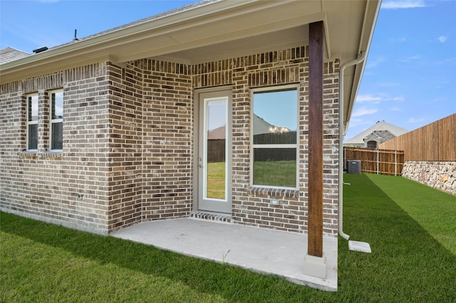 424 Lamb Ln, Waxahachie, TX 75167 - doorway to property featuring a patio, brick siding, fence, and a yard