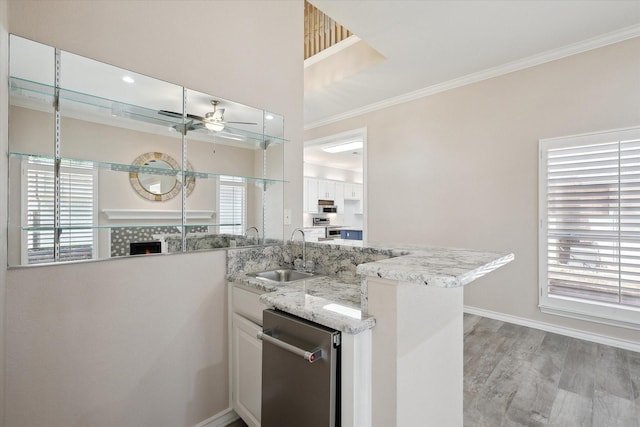 8508 Landing Way Ct, Fort Worth, TX 76179 - kitchen with a sink, ceiling fan, stainless steel dishwasher, ornamental molding, and light wood-style floors