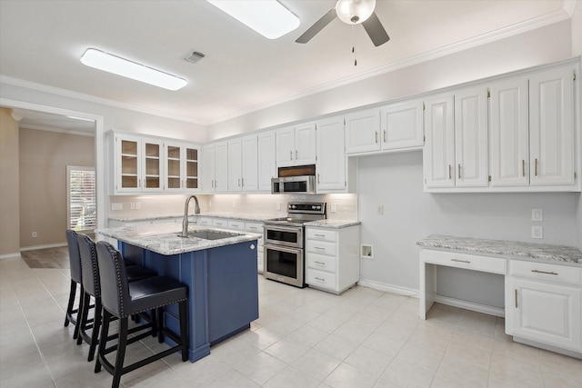 8508 Landing Way Ct, Fort Worth, TX 76179 - kitchen featuring appliances with stainless steel finishes, a sink, white cabinets, light stone counters, and ornamental molding