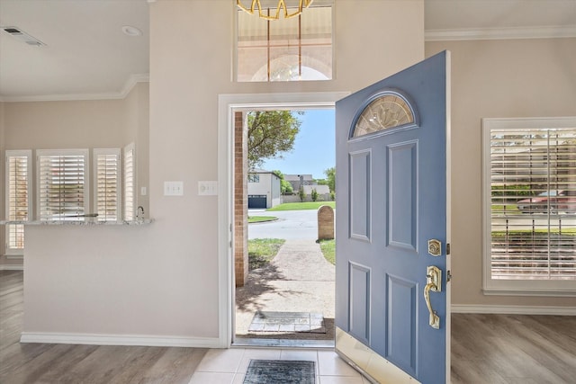 8508 Landing Way Ct, Fort Worth, TX 76179 - entryway with ornamental molding, baseboards, wood finished floors, and a chandelier