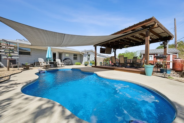 view of swimming pool featuring a patio area and outdoor dining area