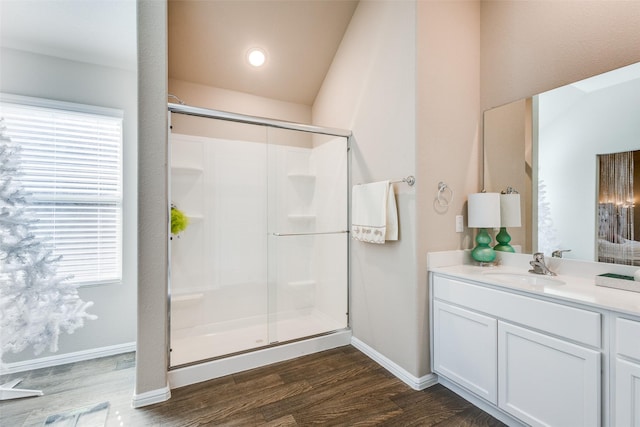 full bathroom with a shower stall, plenty of natural light, and wood finished floors