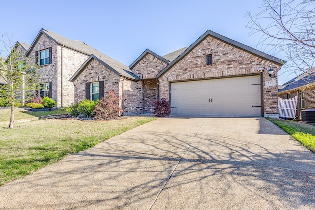 french provincial home featuring a front yard, brick siding, driveway, and an attached garage