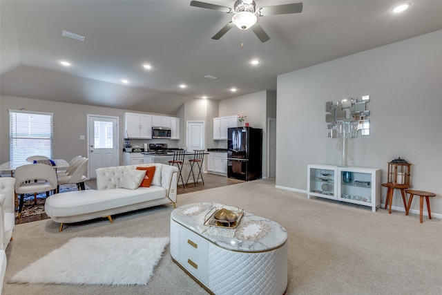 living area featuring light colored carpet, ceiling fan, visible vents, and recessed lighting
