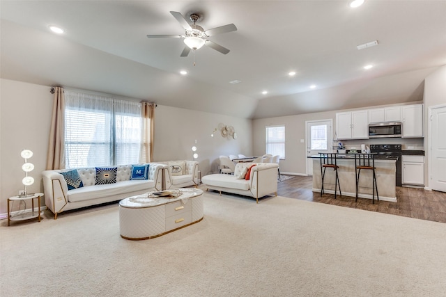 living area featuring carpet floors, recessed lighting, visible vents, and lofted ceiling