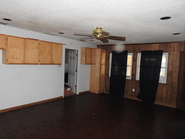 1614 Camero Dr, Carrollton, TX 75006 - unfurnished living room featuring dark wood-style floors, a textured ceiling, baseboards, ceiling fan, and wood walls