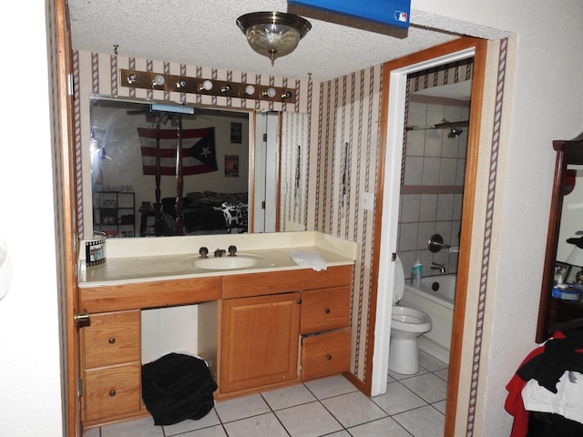 1614 Camero Dr, Carrollton, TX 75006 - bathroom with tile patterned flooring, toilet, vanity, wallpapered walls, and a textured ceiling