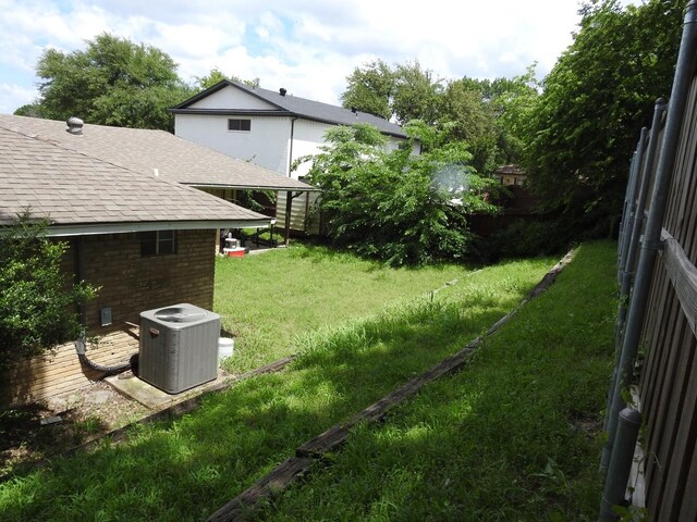 1614 Camero Dr, Carrollton, TX 75006 - view of yard featuring central AC unit and a wooden deck