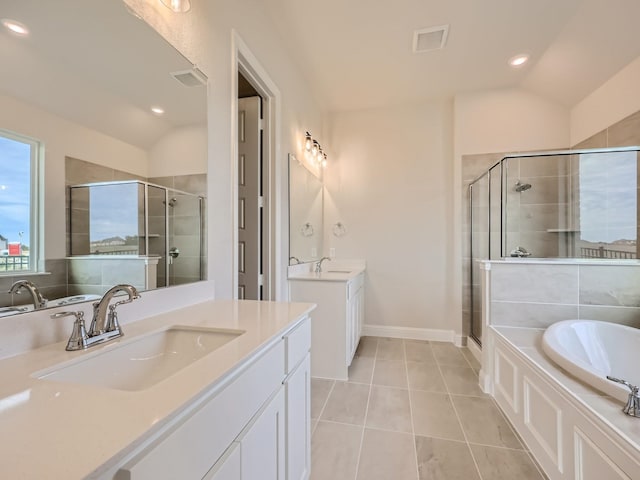 4418 Capstone Rd, Midlothian, TX 76065 - bathroom featuring a stall shower, two vanities, a bath, lofted ceiling, and tile patterned flooring
