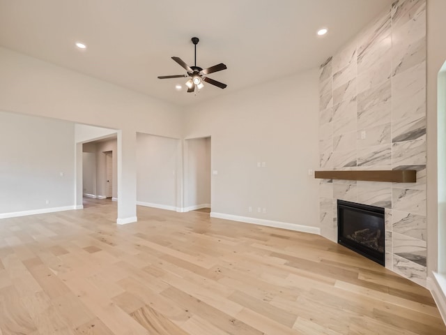 4418 Capstone Rd, Midlothian, TX 76065 - unfurnished living room featuring a tiled fireplace, a ceiling fan, light wood-style floors, recessed lighting, and baseboards