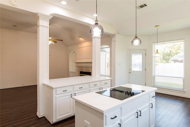 7104 Hillview Dr, Plano, TX 75025 - kitchen featuring dark wood-style flooring, lofted ceiling, ornate columns, a center island, and black electric cooktop