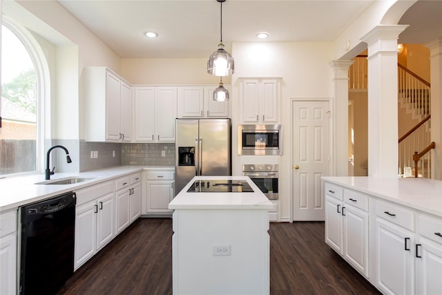 7104 Hillview Dr, Plano, TX 75025 - kitchen featuring dark wood-style flooring, ornate columns, a center island, a sink, and black appliances