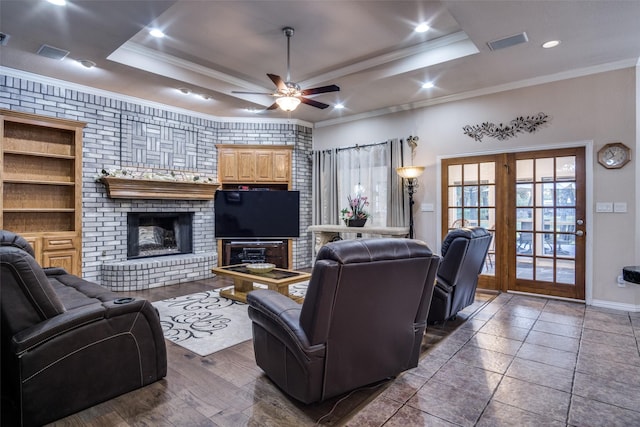 12215 Lake Forest Dr, Azle, TX 76020 - living room featuring ceiling fan, a brick fireplace, crown molding, a raised ceiling, and baseboards
