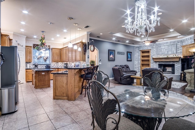 12215 Lake Forest Dr, Azle, TX 76020 - dining room featuring crown molding, a chandelier, a fireplace, light tile patterned floors, and baseboards