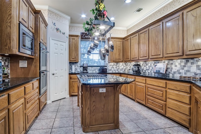 12215 Lake Forest Dr, Azle, TX 76020 - kitchen featuring stainless steel appliances, crown molding, a kitchen island, dark stone counters, and backsplash