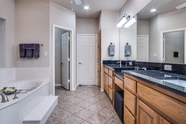 12215 Lake Forest Dr, Azle, TX 76020 - bathroom featuring a bath, double vanity, tile patterned flooring, a ceiling fan, and baseboards