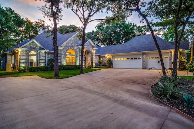 12215 Lake Forest Dr, Azle, TX 76020 - view of front of property with concrete driveway, a garage, stone siding, a yard, and roof with shingles