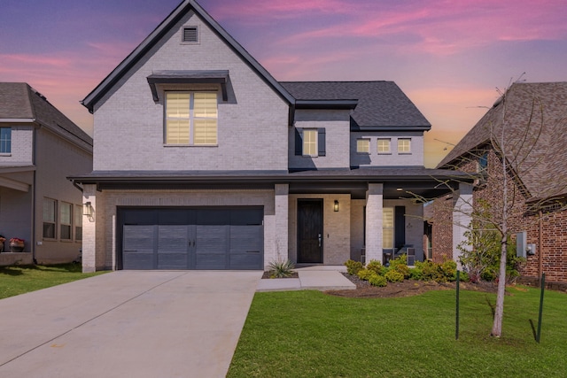 4120 Sandhills Ln, Prosper, TX 75078 - view of front of home with brick siding, covered porch, a front lawn, a garage, and concrete driveway