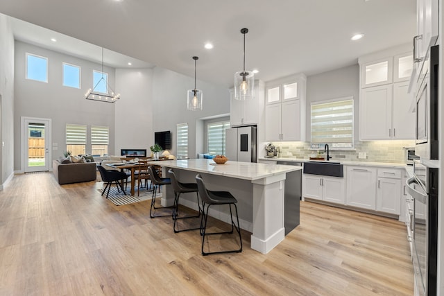 4120 Sandhills Ln, Prosper, TX 75078 - kitchen featuring stainless steel appliances, a sink, recessed lighting, a center island, and white cabinets