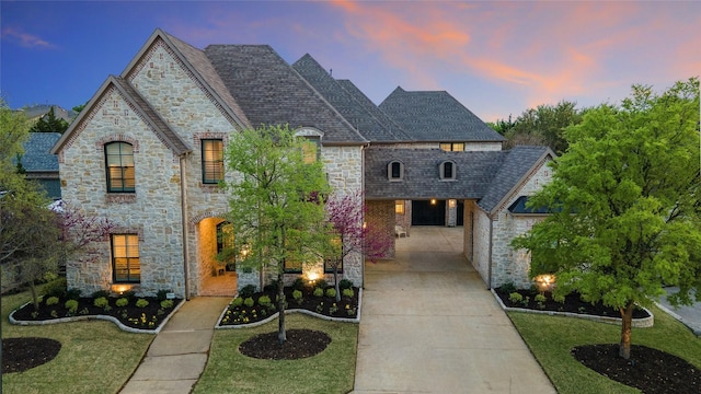 6405 Carmel Falls Ct, Mckinney, TX 75072 - french provincial home featuring a shingled roof, concrete driveway, a yard, and stone siding