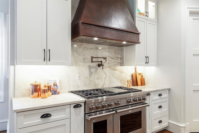 6405 Carmel Falls Ct, Mckinney, TX 75072 - kitchen with decorative backsplash, custom range hood, double oven range, and white cabinets