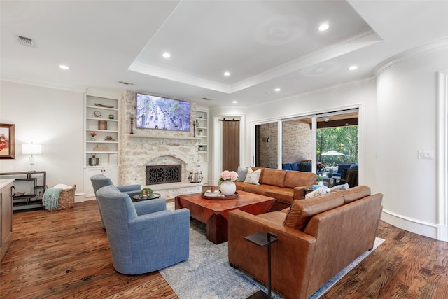 6405 Carmel Falls Ct, Mckinney, TX 75072 - living area featuring visible vents, wood finished floors, ornamental molding, a tray ceiling, and recessed lighting