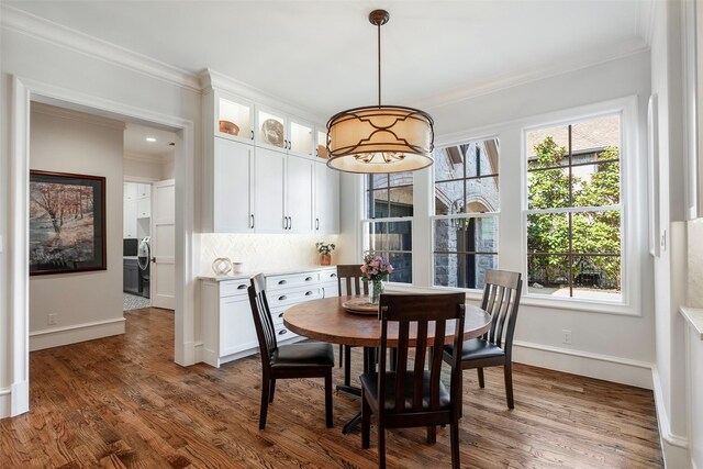 6405 Carmel Falls Ct, Mckinney, TX 75072 - dining space featuring crown molding, baseboards, and dark wood-style flooring
