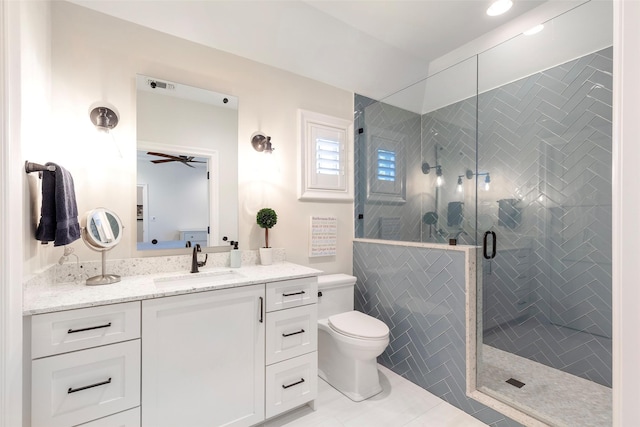 6405 Carmel Falls Ct, Mckinney, TX 75072 - bathroom featuring vanity, ceiling fan, a stall shower, and toilet