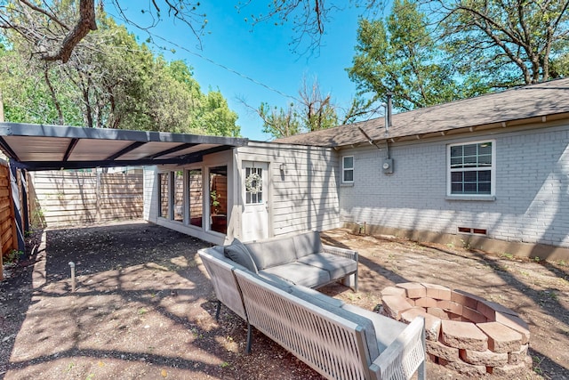 2931 Garapan Dr, Dallas, TX 75224 - rear view of house with aphalt driveway, an outdoor fire pit, a carport, roof with shingles, and brick siding